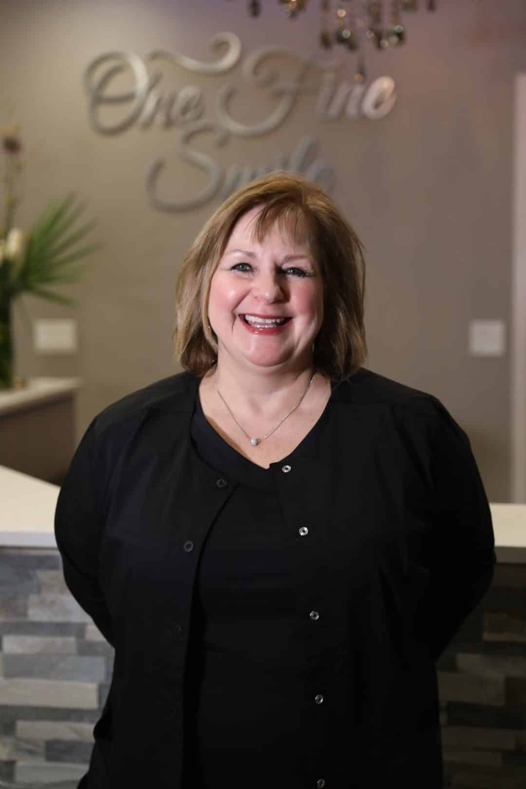 happy dentist in black