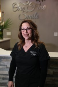 smiling dentist in glasses